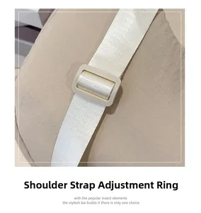 Close-up of adjustable strap buckle and beige woven fabric on the nylon shoulder bag