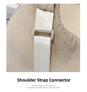 Close-up of durable nylon strap attachment and adjustable buckle on khaki crossbody bag