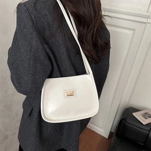 Minimalist cream white shiny PU leather underarm bag with gold logo on gray blazer