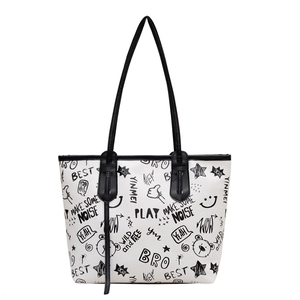 Graffiti print tote bag in black and white contrast with cartoon street art patterns