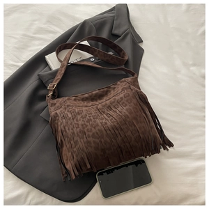 Detail of leopard print fringe shoulder bag with premium suede and gold metal buckles