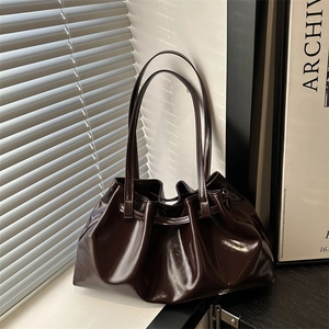 Pleated dark brown oil wax leather shoulder tote bag with a glossy minimalist design