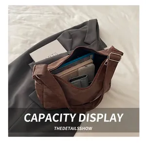 Detailed interior view of brown suede tote showing spacious capacity for books and devices