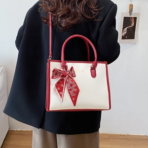 2025 Fashion contrast red and white leather tote bag with silk scarf on a model back view