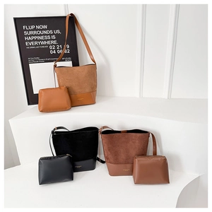 Detail view of stylish bucket bags and matching zip pouches in tan, black and brown
