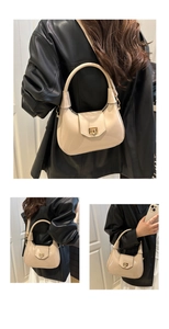 Detail view of mini glossy patent leather handbag with elegant gold twist lock closure