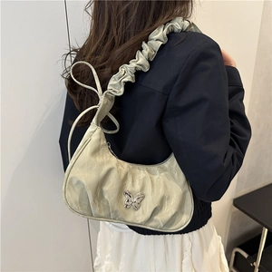 Light green pleated underarm bag with silver butterfly buckle in a sweet chic style