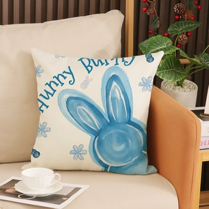 Fodera per cuscino pasquale in lino con stampa a coniglio blu e testo Hunny Bunny su divano