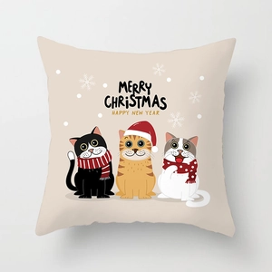 Close-up of square beige Christmas pillowcase with three cute cartoon cats and snowflakes