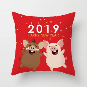 Detail of red square pillowcase with Happy New Year 2019 cartoon pigs on soft fabric