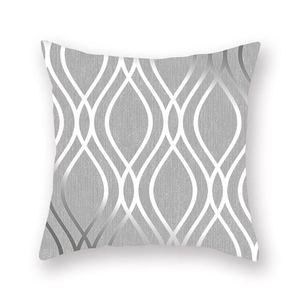 Detail of silver-grey pillowcase with metallic geometric wave lines on peach skin fabric
