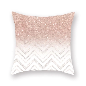Macro shot of rose gold glitter chevron and gradient sequin patterns on cushion cover