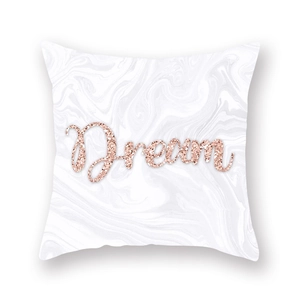 Detail of soft peach skin pillowcase with marble pattern and rose gold Dream text