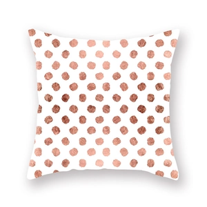 Macro shot of rose gold metallic polka dot texture on white peach skin fabric cushion
