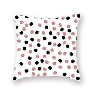 Detailed close-up of square peach skin pillowcase featuring rose gold and black polka dots