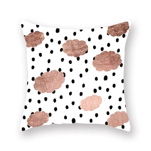 Detail of rose gold foil cloud and black polka dots on white microfiber pillow cover