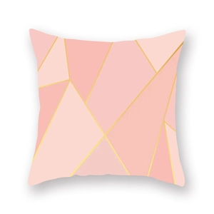 Detail of rose gold geometric patchwork cushion cover with soft velvet peach skin texture