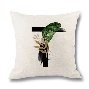 Linen cushion cover with letter T and tropical green leaves on white background