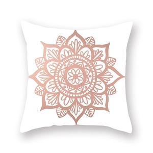 Close-up of rose gold mandala floral pattern on a soft white peach skin pillowcase
