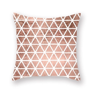 Detail of square pillowcase with geometric rose gold triangle patterns on white background