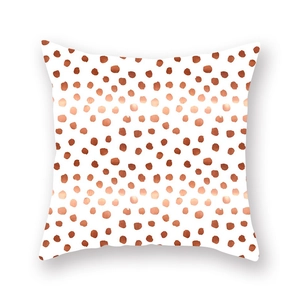 Close-up of peach skin pillowcase with irregular reddish-brown and orange dots pattern