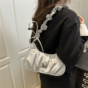Silver pleated underarm bag with butterfly metal accent and ruffled shoulder strap