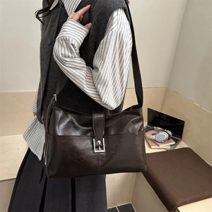 Large vintage coffee brown leather tote bag for women shown in a stylish commuting scene