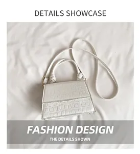 Detailed macro view of white faux leather crossbody bag with crocodile skin texture