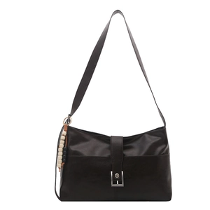 Retro brown leather tote bag with silver buckle and ethnic bead charm on white background