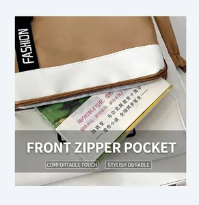Close-up of dual-tone canvas bag with front zipper pocket and decorative fashion strap