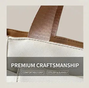 Detailed close-up of white twill canvas fabric and brown nylon handle stitching