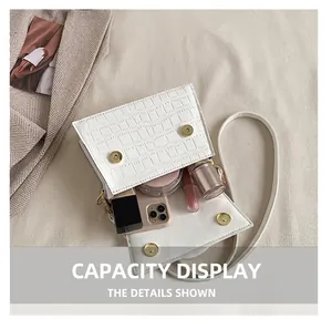 Interior view of white crocodile pattern square bag showing storage capacity for essentials