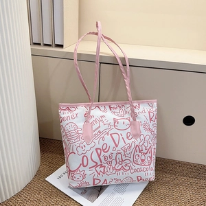 Detail shot of white tote bag featuring pink graffiti patterns and stylish leather straps