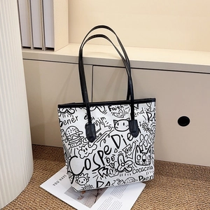 Macro detail of graffiti print tote bag showing creative urban patterns and sturdy handles