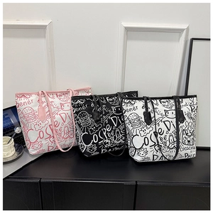 Detailed view of large graffiti print tote bags in canvas featuring pop art feline designs
