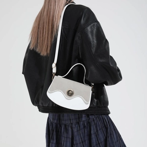 Vintage tote bag with gold clasp and two-tone design shown on model for daily commute