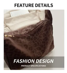 Detail view of leopard print crossbody bag with gold zipper and textured synthetic leather