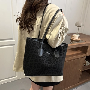 Chic leopard print leather tote bag with FASHION logo shown in a lifestyle setting