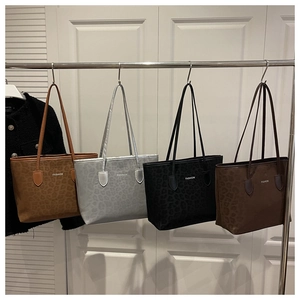 Detailed view of four retro leopard print tote bags in brown, black, and silver colors