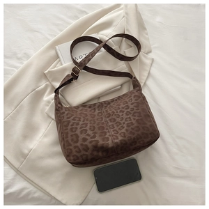 Detail view of large brown leopard print shoulder bag in soft suede with adjustable strap