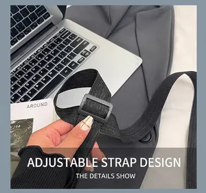 Detail of adjustable black corduroy bag strap with heavy duty plastic buckle on a desk