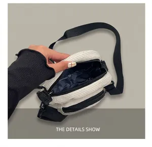 Detail view of corduroy crossbody bag interior space and durable zipper compartment