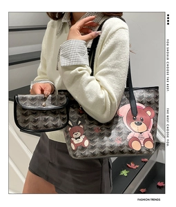 Détail d'un grand sac fourre-tout imprimé ours avec pochette assortie sur un escalier
