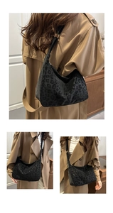 Detail of black leopard print hobo bag showing velvety texture and adjustable strap