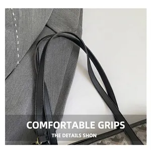 Détail des poignées en similicuir noir sur un sac fourre-tout à motif géométrique