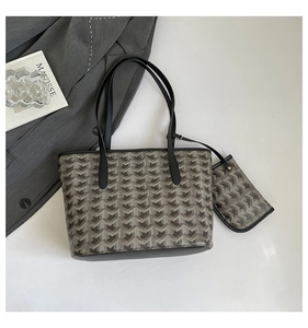 Detail of large reversible tote bag with geometric print and matching mini pouch bag