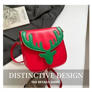 Détail du sac bandoulière de Noël en cuir rouge avec des bois de renne verts