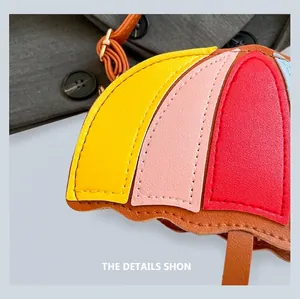 Detail shot of multi-color umbrella shaped leather bag showing fine stitching and metal buckles