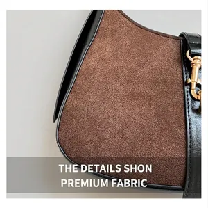 Close-up of brown suede fabric with black leather trim and gold metal hook detail