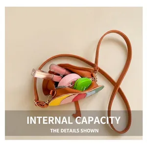 Detailed interior of a brown bucket bag with colorful stitching showing its storage capacity